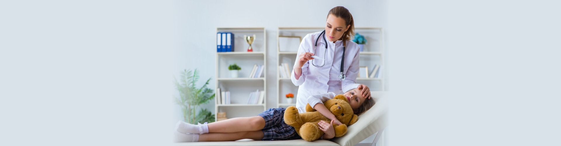 doctor checking kid temperature