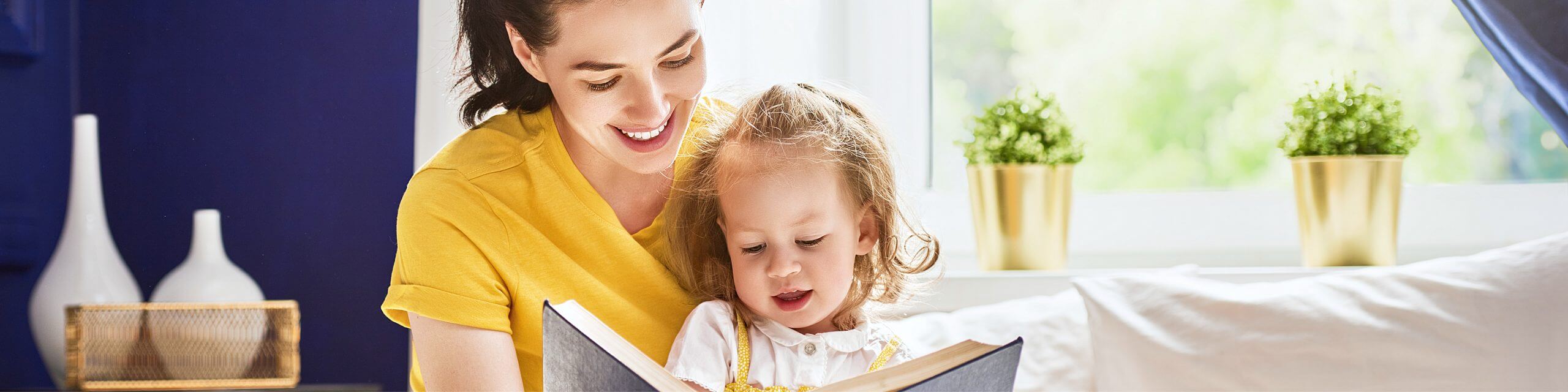 mother reading a book to her daughter